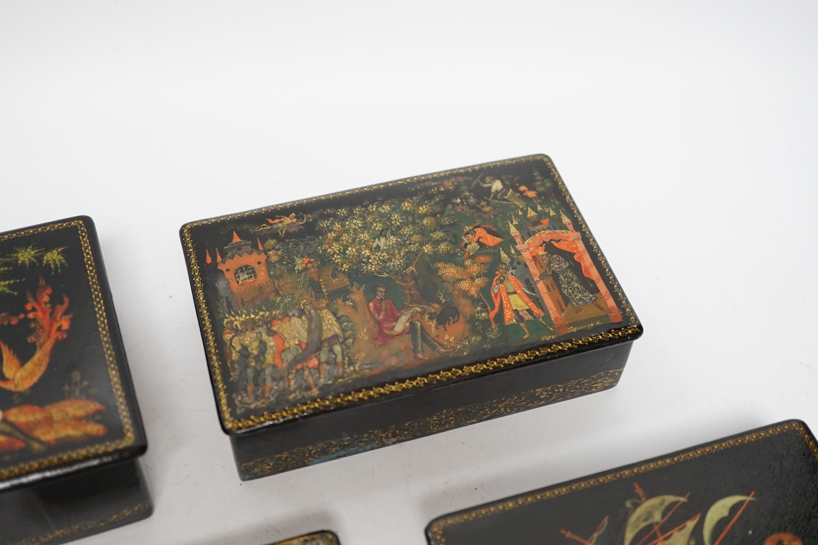Five Russian Palekh lacquer table boxes, each painted with figures from legend, each signed by the artist, the largest 17 cm wide